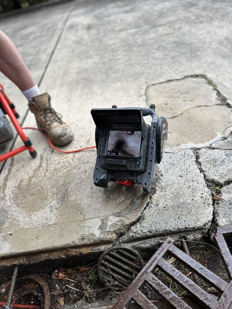 CCTV camera inspecting a pipe for replacement vs relining