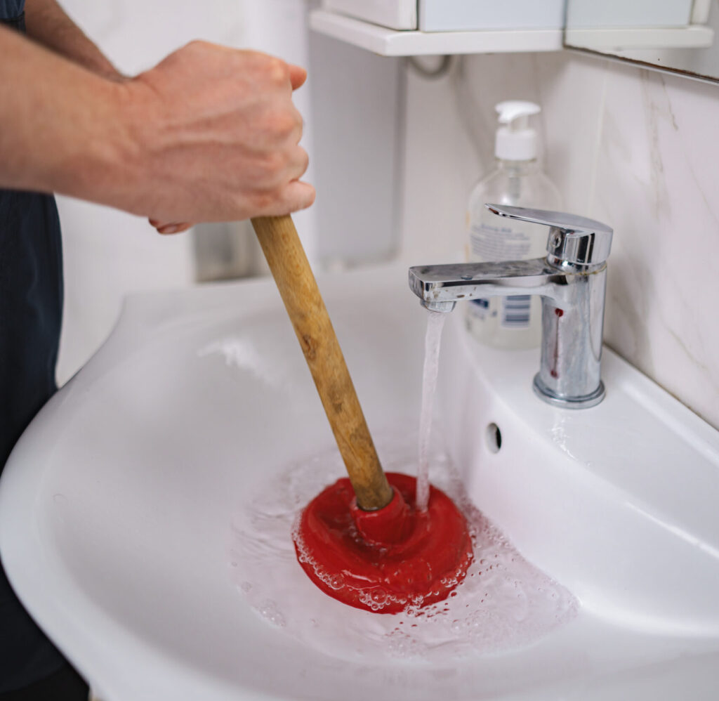 plumber using plunger in bathroom sink 2025 08 03 03 09 28 utc scaled e1759914045363